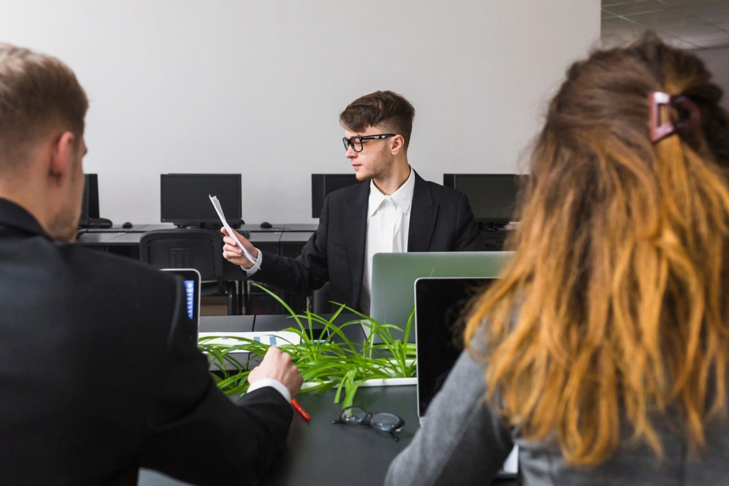 Finanzplanung am Laptop mit Dokumenten und Taschenrechner